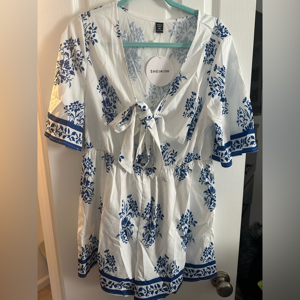 Never worn! Blue and white romper with tie in front and key hole